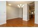 Open-concept dining room with hardwood floors, wainscoting, chandelier, adjacent to kitchen at 7646 Winners Edge St, Raleigh, NC 27617