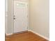 Clean entryway featuring hardwood floors and white door, offering a welcoming first impression at 7646 Winners Edge St, Raleigh, NC 27617