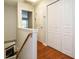 Hallway with hardwood floors, a closet, and access to other rooms at 7646 Winners Edge St, Raleigh, NC 27617