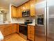 Modern kitchen featuring stainless steel appliances, wooden cabinetry, and bright countertops at 7646 Winners Edge St, Raleigh, NC 27617