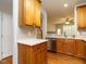 Functional kitchen featuring wooden cabinets, stainless steel appliances, and a view to the living room at 7646 Winners Edge St, Raleigh, NC 27617