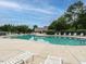 Community pool with lounge chairs and clubhouse at 7646 Winners Edge St, Raleigh, NC 27617
