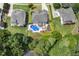 Aerial view showcasing a private backyard oasis featuring an inground pool and well-manicured landscaping at 825 Highwater Pl, Fuquay Varina, NC 27526