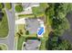Aerial view of a home with an inground pool and landscaped yard near a pond at 825 Highwater Pl, Fuquay Varina, NC 27526