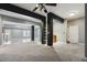 Spacious carpeted basement with black support beams and neutral walls, perfect for versatile living at 825 Highwater Pl, Fuquay Varina, NC 27526
