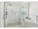 Bathroom featuring a glass shower, soaking tub, and marble-like tile at 825 Highwater Pl, Fuquay Varina, NC 27526