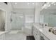 Bathroom featuring a glass shower, soaking tub, and marble-like tile at 825 Highwater Pl, Fuquay Varina, NC 27526