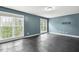 Large bedroom featuring hardwood floors, big windows, and a fixture for TV at 825 Highwater Pl, Fuquay Varina, NC 27526