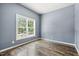 Bright bedroom with hardwood floors, large window and neutral walls for a serene feel at 825 Highwater Pl, Fuquay Varina, NC 27526