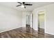 Light-filled bedroom with hardwood floors and an open closet at 825 Highwater Pl, Fuquay Varina, NC 27526