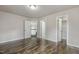 Spacious bedroom featuring hardwood floors and three doors at 825 Highwater Pl, Fuquay Varina, NC 27526
