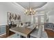 Tastefully designed dining area with modern lighting, elegant decor, and hardwood floors at 825 Highwater Pl, Fuquay Varina, NC 27526