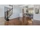 Elegant dining room with hardwood floors, decorative columns, and a stylish chandelier at 825 Highwater Pl, Fuquay Varina, NC 27526