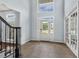 Well-lit foyer with soaring ceiling and large windows, showcasing the grand entrance and staircase at 825 Highwater Pl, Fuquay Varina, NC 27526