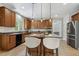 Kitchen with tile floors, granite countertops, pendant lights, and a breakfast bar with seating at 825 Highwater Pl, Fuquay Varina, NC 27526
