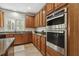 This kitchen features granite countertops, stainless steel double oven, and wood cabinets at 825 Highwater Pl, Fuquay Varina, NC 27526