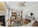 Spacious living room with hardwood floors, ceiling fan, fireplace and views of the kitchen at 825 Highwater Pl, Fuquay Varina, NC 27526