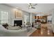 Open concept living room and kitchen with hardwood floors, fireplace and breakfast bar at 825 Highwater Pl, Fuquay Varina, NC 27526