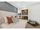 Modern main bedroom features a connected kitchenette with wood cabinets and a grey accent wall at 825 Highwater Pl, Fuquay Varina, NC 27526