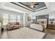 Spacious main bedroom featuring a tray ceiling, lots of natural light, and modern decor at 825 Highwater Pl, Fuquay Varina, NC 27526