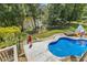 Inviting in-ground pool surrounded by lush landscaping and mature trees for a private setting at 825 Highwater Pl, Fuquay Varina, NC 27526