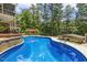 Large in-ground pool and backyard offers a private oasis with lush greenery at 825 Highwater Pl, Fuquay Varina, NC 27526