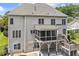 Back of home featuring a screened porch, deck, and access to the backyard and patios at 825 Highwater Pl, Fuquay Varina, NC 27526