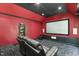 Home theater in basement features a large screen, tiered seating and full electronics at 825 Highwater Pl, Fuquay Varina, NC 27526
