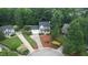 Aerial shot of a gray home with black shutters in a lush, green, tree-filled neighborhood at 9020 Branch Creek Way, Apex, NC 27539