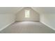 Spacious attic space with carpet and a window for ventilation at 9020 Branch Creek Way, Apex, NC 27539