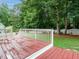 Back deck, with railing and a manicured lawn at 9020 Branch Creek Way, Apex, NC 27539