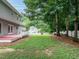 House backyard featuring lawn and green trees at 9020 Branch Creek Way, Apex, NC 27539