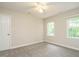 Bright bedroom with neutral walls, carpet, and ample natural light from two windows at 9020 Branch Creek Way, Apex, NC 27539