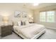 Serene bedroom features neutral tones, a large window, and comfortable furniture at 9020 Branch Creek Way, Apex, NC 27539