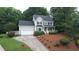 A charming two-story home with a manicured lawn, attached garage, and a classic gray exterior at 9020 Branch Creek Way, Apex, NC 27539