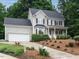 Charming two-story home with a manicured front yard, a two-car garage, and a welcoming porch at 9020 Branch Creek Way, Apex, NC 27539