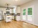 Bright kitchen with stainless appliances, a kitchen island, and adjacent french doors at 9020 Branch Creek Way, Apex, NC 27539