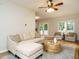 Comfortable living room with a large sectional sofa, hardwood floors, and a view to the back yard at 9020 Branch Creek Way, Apex, NC 27539