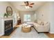 Inviting living room featuring hardwood floors, a fireplace, and neutral-toned furniture at 9020 Branch Creek Way, Apex, NC 27539