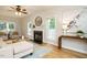Cozy living room showcasing hardwood floors, a fireplace, and neutral-toned furniture at 9020 Branch Creek Way, Apex, NC 27539