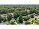 Aerial of the property in a neighborhood featuring big trees at 907 Stuart Dr, Mebane, NC 27302