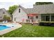 Backyard with a pool, patio, and spacious lawn perfect for outdoor living and entertaining at 907 Stuart Dr, Mebane, NC 27302