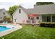 Private backyard featuring a pool, patio, and a manicured lawn at 907 Stuart Dr, Mebane, NC 27302