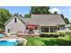 Backyard features a pool, a large deck with a red umbrella, and lush green lawn with manicured landscaping at 907 Stuart Dr, Mebane, NC 27302