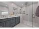 Stylish bathroom features a double vanity and walk-in shower with mosaic tile accents at 907 Stuart Dr, Mebane, NC 27302
