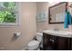 Half bathroom with a vanity, toilet and window for natural light at 907 Stuart Dr, Mebane, NC 27302