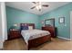 Comfortable bedroom features a wood bed frame, dresser, and calming blue walls at 907 Stuart Dr, Mebane, NC 27302
