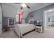 Sloped ceiling in this bedroom with window, carpet and connected bathroom at 907 Stuart Dr, Mebane, NC 27302