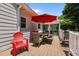 Outdoor dining on the deck, complete with a table, chairs, and a red umbrella for shade at 907 Stuart Dr, Mebane, NC 27302