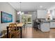 Open concept kitchen and dining area with breakfast bar and access to the backyard at 907 Stuart Dr, Mebane, NC 27302